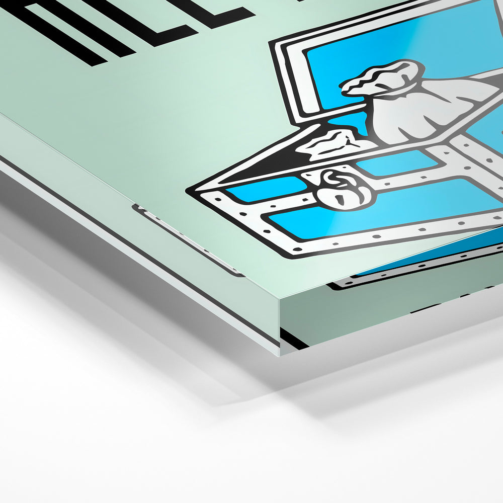 Gros plan de la matière : le tirage sous verre acrylique, tranche transparente visible.