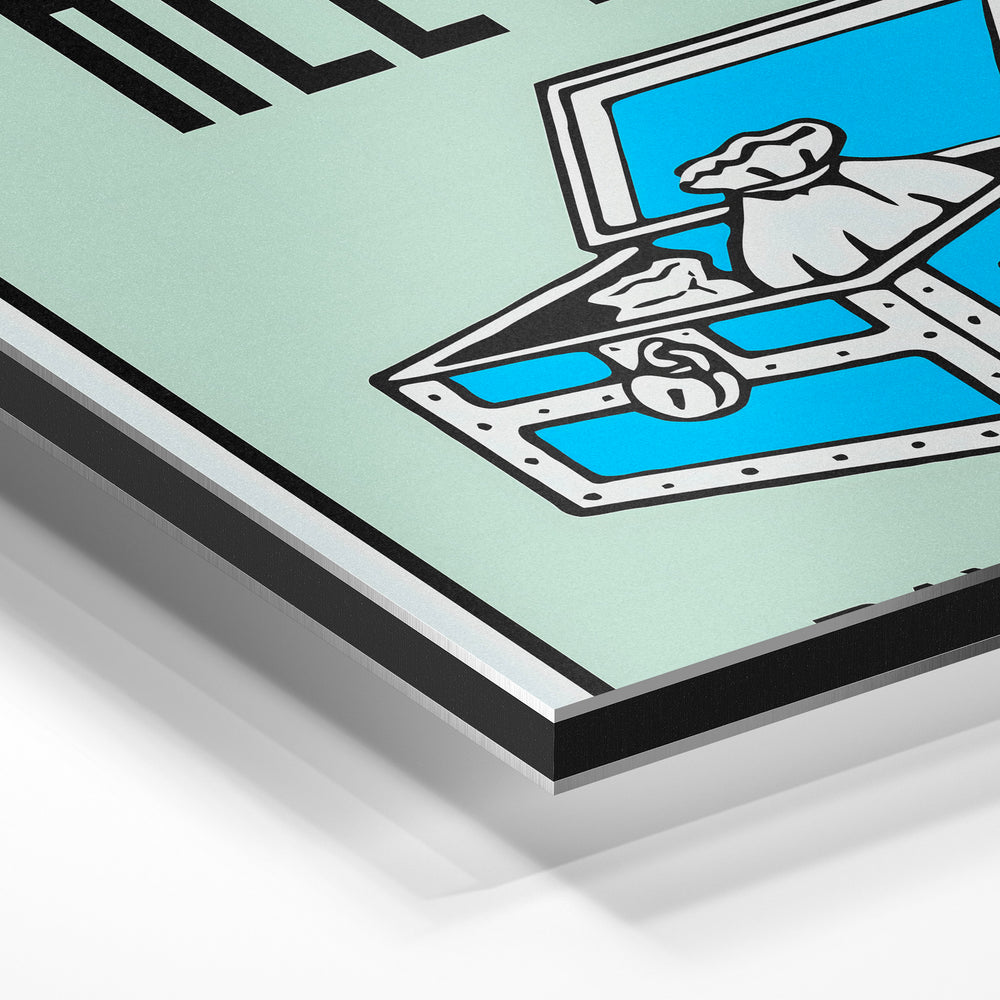 Gros plan de la matière : le tirage contrecollé sur aluminium Dibond mat, tranche visible.