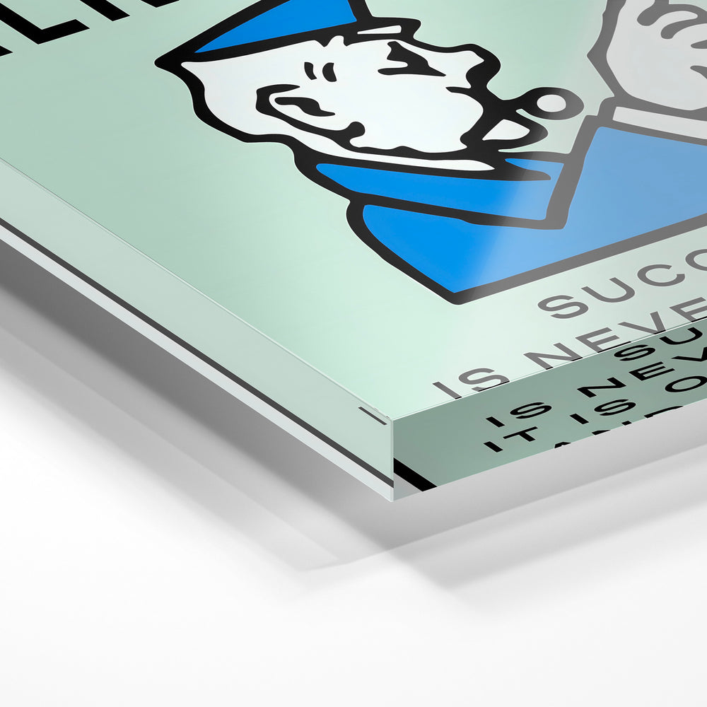 Gros plan de la matière : le tirage sous verre acrylique, tranche transparente visible.