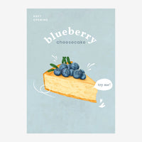 Illustration d'une part de cheesecake aux myrtilles garnie de fruits frais sur fond bleu ciel, avec texte « blueberry.