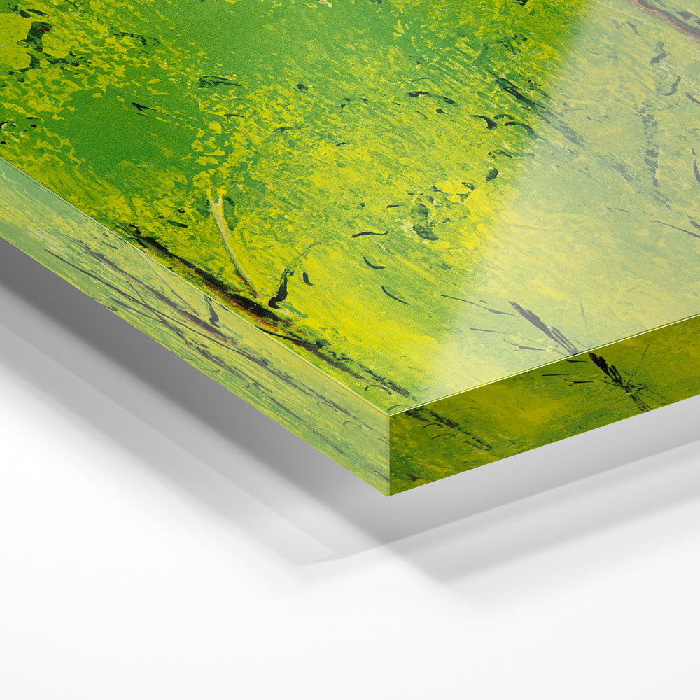 Gros plan de la matière : le tirage sous verre acrylique, tranche transparente visible.