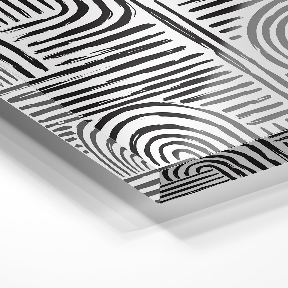 Gros plan de la matière : le tirage sous verre acrylique, tranche transparente visible.