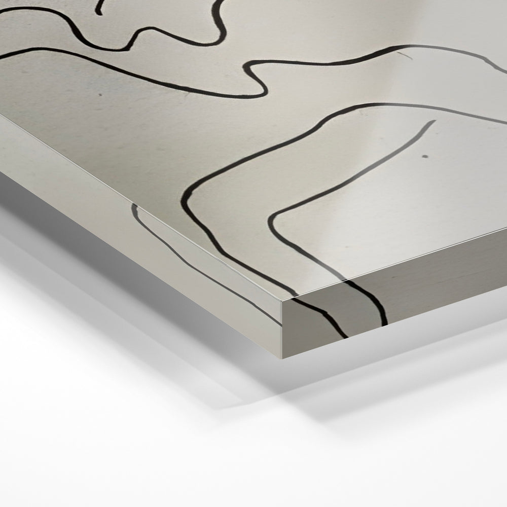 Gros plan de la matière : le tirage sous verre acrylique, tranche transparente visible.