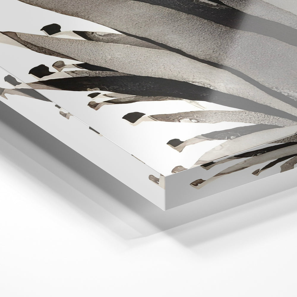Gros plan de la matière : le tirage sous verre acrylique, tranche transparente visible.