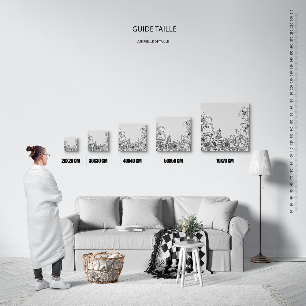 Guide des tailles : le tirage présenté dans ses 5 formats de vente, à l'échelle réelle sur un mur de salon, avec une règle en centimètres.