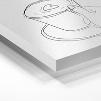 Gros plan de la matière : le tirage sous verre acrylique, tranche transparente visible.