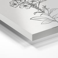 Gros plan de la matière : le tirage sous verre acrylique, tranche transparente visible.