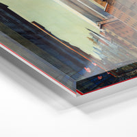 Gros plan de la matière : le tirage sous verre acrylique, tranche transparente visible.